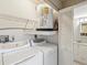 Laundry room features a side-by-side washer and dryer, water heater, and storage space at 12920 Wedgewood Way # B, Hudson, FL 34667