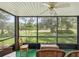 Enclosed patio with green outdoor carpet, wicker furniture, and views of the landscaped yard at 12920 Wedgewood Way # B, Hudson, FL 34667