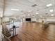 Spacious recreation room with wood floors, stage, ceiling fans, and ample seating for various activities at 12920 Wedgewood Way # B, Hudson, FL 34667