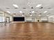 Large recreation room features a stage, ceiling fans, and plenty of space for community events and gatherings at 12920 Wedgewood Way # B, Hudson, FL 34667