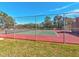 Community tennis court with green and red surface is perfect for friendly matches and exercise at 12920 Wedgewood Way # B, Hudson, FL 34667