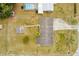 Bird's eye view showing a well-maintained backyard with a driveway, shed, and green landscape at 12936 Parkwood St, Hudson, FL 34669