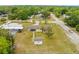 An aerial view showing the layout of a single-Gathering home with a pool, long driveway and spacious yard at 12936 Parkwood St, Hudson, FL 34669