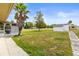 Spacious backyard featuring a shed, palm tree and healthy green grass at 12936 Parkwood St, Hudson, FL 34669