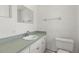 Well-lit bathroom features a stylish vanity with a sleek countertop, a mirror, and a toilet at 12936 Parkwood St, Hudson, FL 34669