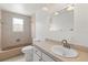 Bright bathroom featuring a vanity with a sink, a tub with shower, and tiled walls at 12936 Parkwood St, Hudson, FL 34669