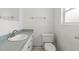 Well-lit bathroom features a stylish vanity with a sleek countertop, a mirror, and a toilet at 12936 Parkwood St, Hudson, FL 34669