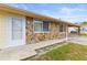 Charming single-story home featuring stone accents, a covered carport, and a welcoming front entrance at 12936 Parkwood St, Hudson, FL 34669