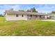 This single story home has stone accents and a well maintained lawn giving it a welcoming curb appeal at 12936 Parkwood St, Hudson, FL 34669