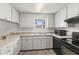 Kitchen with stainless steel appliances, neutral countertops, and ample storage space at 12936 Parkwood St, Hudson, FL 34669