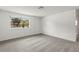 Bright living room features neutral carpet, white walls, a large window and white door for ample natural light at 12936 Parkwood St, Hudson, FL 34669