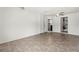 Bright living room featuring neutral tile floors with white walls, a ceiling fan, and laundry space at 12936 Parkwood St, Hudson, FL 34669