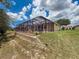 Well maintained backyard with pool, lanai, retaining wall, landscaping, and grass area at 13248 Linzia Ln, Spring Hill, FL 34609