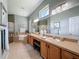 Bright and airy bathroom with double sinks, natural light, tub, separate shower, and neutral tile floors at 13248 Linzia Ln, Spring Hill, FL 34609