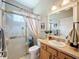 This quaint bathroom includes a shower with a glass door, single vanity with storage, and neutral color scheme at 13248 Linzia Ln, Spring Hill, FL 34609