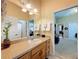 Bathroom offers a well-lit vanity, a large mirror, and a glimpse into other rooms, enhancing spaciousness at 13248 Linzia Ln, Spring Hill, FL 34609