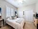 Bright bedroom featuring a full bed, shuttered window, and double closets, offering a cozy and functional retreat at 13248 Linzia Ln, Spring Hill, FL 34609