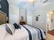Comfortable bedroom with neutral walls, plush bedding, and a view leading to the ensuite bathroom at 13248 Linzia Ln, Spring Hill, FL 34609