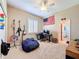 Bedroom features an American flag, guitars, and a beanbag chair, creating a fun, casual space at 13248 Linzia Ln, Spring Hill, FL 34609
