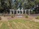 The community entrance has a decorative pergola and well-maintained landscaping at 13248 Linzia Ln, Spring Hill, FL 34609