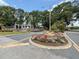 Landscaped community entrance featuring lush greenery and decorative flowers at 13248 Linzia Ln, Spring Hill, FL 34609