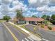 Charming single-story community center with a red tile roof, ample parking, and mature landscaping at 13248 Linzia Ln, Spring Hill, FL 34609