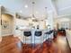 Open-concept kitchen with a breakfast bar, pendant lighting, and hardwood flooring at 13248 Linzia Ln, Spring Hill, FL 34609