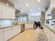 Bright kitchen features stainless steel appliances, white cabinets, and a view into the breakfast nook at 13248 Linzia Ln, Spring Hill, FL 34609