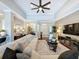 Bright, open-concept living room with hardwood floors and a seamless flow to other living spaces at 13248 Linzia Ln, Spring Hill, FL 34609