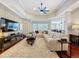 Bright living room with tray ceilings, modern decor, and an open layout at 13248 Linzia Ln, Spring Hill, FL 34609