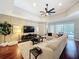 Open-concept living room with large windows, backyard access, and a stylish sectional sofa at 13248 Linzia Ln, Spring Hill, FL 34609