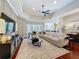 Spacious living room with a large sectional sofa and views of the adjacent kitchen at 13248 Linzia Ln, Spring Hill, FL 34609