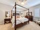 Elegant main bedroom featuring a dark wood four poster bed, decorative furniture, and plantation shutters at 13248 Linzia Ln, Spring Hill, FL 34609
