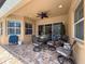 Covered patio with outdoor dining area, neutral tones, stylish furnishings, and tranquil outdoor space at 13248 Linzia Ln, Spring Hill, FL 34609