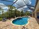 Sparkling pool with screened enclosure, lush landscaping, outdoor seating, and inviting outdoor living space at 13248 Linzia Ln, Spring Hill, FL 34609
