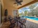 Covered patio with outdoor dining area overlooking screened pool with lush landscaping and inviting outdoor living at 13248 Linzia Ln, Spring Hill, FL 34609