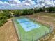 Well-maintained community tennis court surrounded by secure fencing at 13248 Linzia Ln, Spring Hill, FL 34609