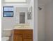 Bathroom with a vanity, a shower, and a window allowing natural light at 13307 Woodward Dr, Hudson, FL 34667