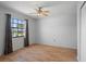 This bedroom offers great natural lighting from the window and a ceiling fan at 13307 Woodward Dr, Hudson, FL 34667