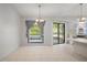 A dining area with tile floors, natural light, and access to the kitchen at 13307 Woodward Dr, Hudson, FL 34667