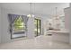 Dining area featuring tile floors, sliding glass doors, and access to the kitchen at 13307 Woodward Dr, Hudson, FL 34667