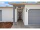 Home's front entrance features a secure door, brick-paved entryway, and clearly visible address at 13307 Woodward Dr, Hudson, FL 34667