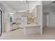 An open kitchen featuring white cabinets and a breakfast bar at 13307 Woodward Dr, Hudson, FL 34667