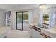 Bright kitchen with a sliding door to screened patio, tile flooring, and efficient layout at 13307 Woodward Dr, Hudson, FL 34667