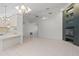 Spacious living room with tile flooring, fireplace, and open layout to the kitchen at 13307 Woodward Dr, Hudson, FL 34667