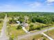 Aerial view of the property showcasing the house, barn, and expansive greenery at 14031 Hexam Rd, Brooksville, FL 34613