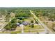 Aerial view of a secluded home featuring a fenced yard, screened-in pool, and lush green surroundings at 14031 Hexam Rd, Brooksville, FL 34613