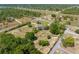Aerial view of property showing home, in-ground pool, large outbuilding, and lush landscaping at 14031 Hexam Rd, Brooksville, FL 34613