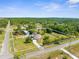 Expansive aerial shot of a home with mature trees, a long driveway and surrounding green space at 14031 Hexam Rd, Brooksville, FL 34613