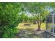 Backyard featuring a fire pit with woodpile, stepping stone path and a wooded fence line at 14031 Hexam Rd, Brooksville, FL 34613